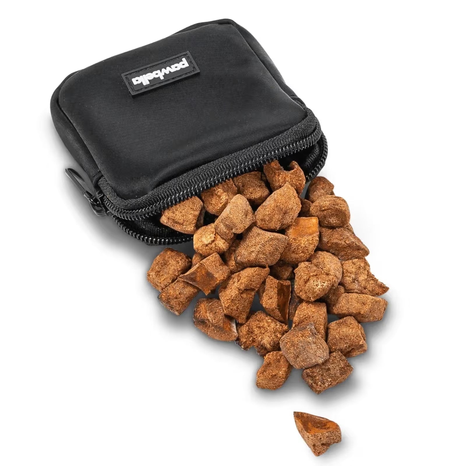 A small black Crossbody Dog Walking Bag by Pawbella spills out brown, chunky dog treats onto a white surface—perfect to toss into your pet backpack.