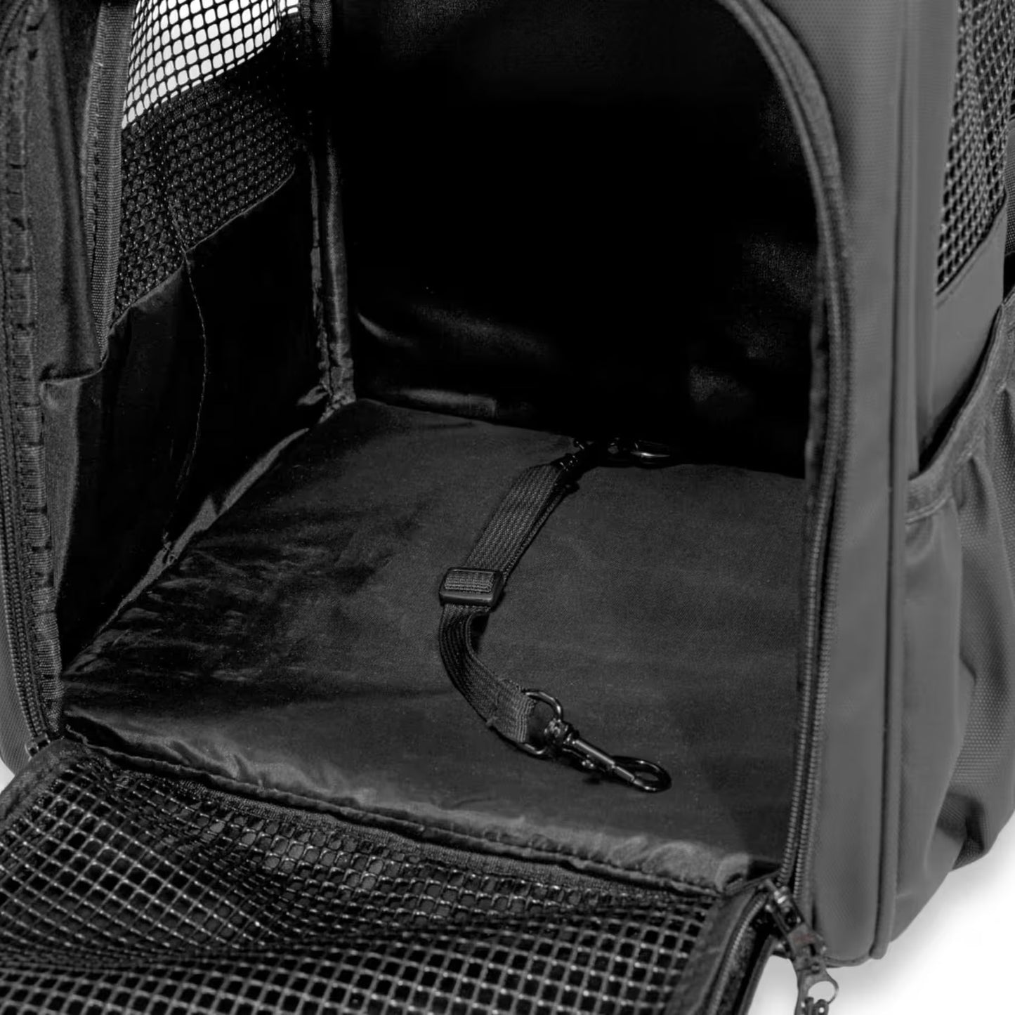A close-up of the Pawbella Outback Explorer Heavy Duty Pet Backpack (12kg max) shows its soft padded mat, mesh ventilation panels, and an interior floor safety strap with clip.
